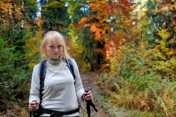 Fototapeta na wymiar Hiker trekking in autumn forest and mountains