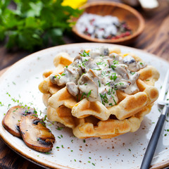 Savory waffles with corn, mushroom creamy sauce on a plate