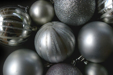 Silver Christmas baubles on black background