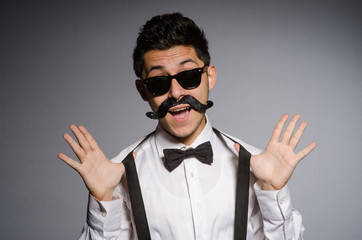 Obraz premium Young man in black sunglasses isolated on gray