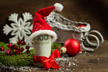 Gift money with red ribbon and Santa cap