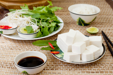 Fresh tofu with rice, salad and soy sauce.