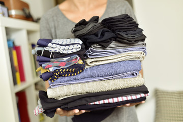 young man with a pile of folded clothes