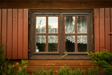 Fototapeta na wymiar Dirty windows and shutters in the wooden house the countryside