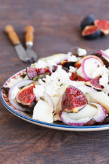 Salad with figs and melon, sprinkled with  cheese