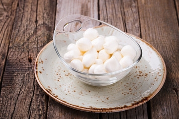 Round mini mozzarella in a glass bowl. selective focus