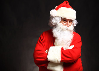 Photo of happy Santa Claus in eyeglasses looking at camera