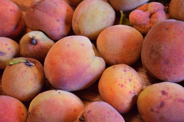 Ripe organic peaches on wooden table