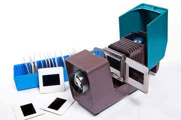 Old projector for displaying of slides. Slides in blue box on wh