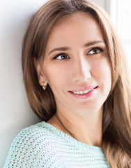 Close up portrait of thoughtful smiling girl