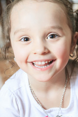 Three year old cute girl playing with connecting blocks