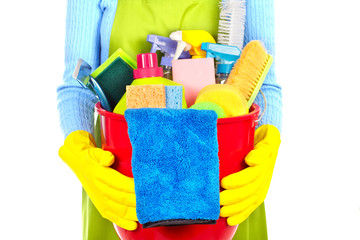 Maid hands with cleaning tools.