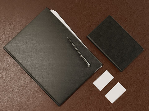 Folder and office supplies on brown leather