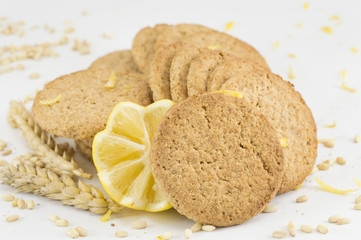 Integral biscuits and decorated lemon on white background