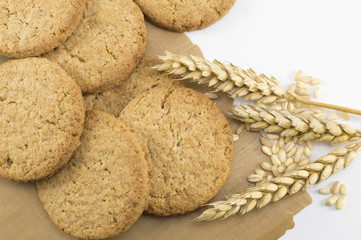 Integral cookies and wheat plant on the cooking paper