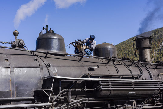 Steam Train Engineer Polishing the Engines Bell