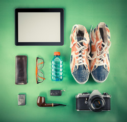 Set of Retro hipster mock up. Laptop, old camera, tablet and smoke pipe on green background....