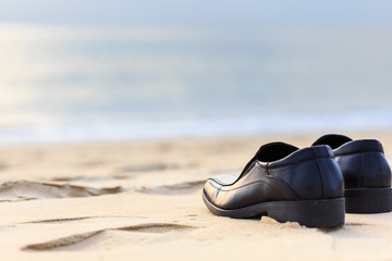 Fototapeta na wymiar Black man leather shoe on the beach
