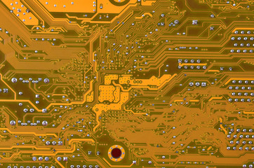 Close up of a printed orange computer circuit board