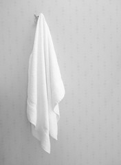 Soft white towel hanging in bathroom interior