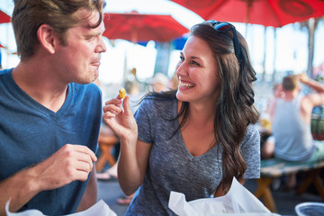 happy couple eating french fries together