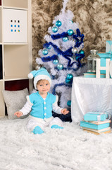 Fototapeta na wymiar little child in christmas interior in blue