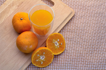 top view of Oranges cut set  and glass of orange juice