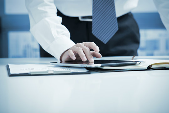 Businessman Using Digital Tablet In Office