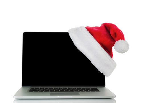 Traditional holiday Christmas hat and laptop computer isolated 