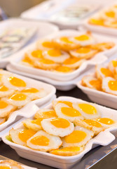 Fried quail egg with foam plate.