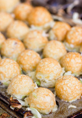 Takoyaki ball the Japanese sweetmeat at food market.