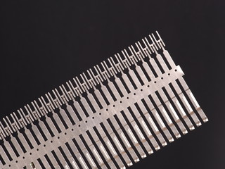 Stamped and plated row of precision springs on black background, Australia 2015 - 94982947