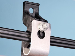 Reinforced plastic and metal cable support clamp with figure 8 cable sample on blue background,...