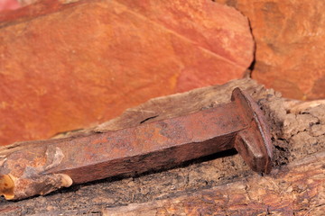 Rusted nail of the original Ghan railway line on a piece of rotten timber near Alice Springs, Australia 2015