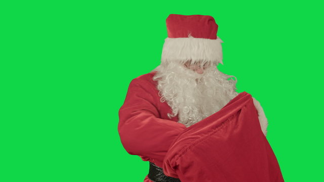 Real Santa Claus carrying presents in his sack on a Green Screen Chrome Key