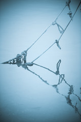 Reflection of boat rope in the water