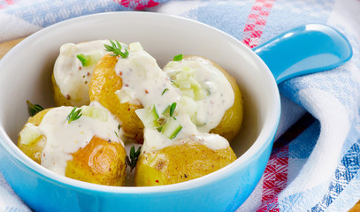 Baked potatoes with cream and herbs.