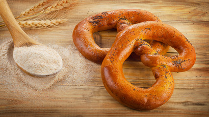 Freshly baked pretzels on  a old wooden table.