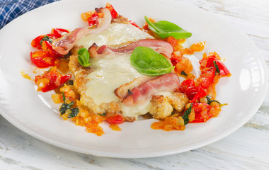 Chicken breast baked with cheese, bacon and tomatoes.