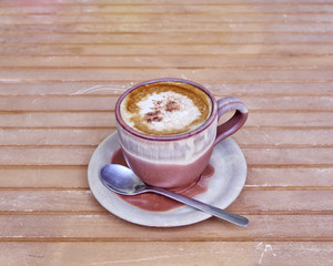 capuccino coffee in brown cup, cinnamon assorted