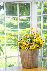 Artificial flowerpot near the glass window