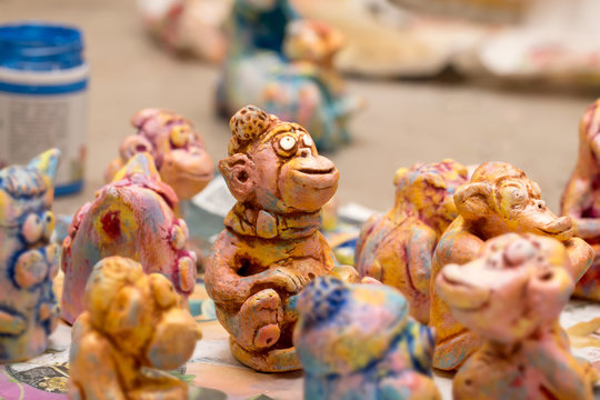 Painted Colorful Handmade Clay figurines of monkeys. Selective Focus.