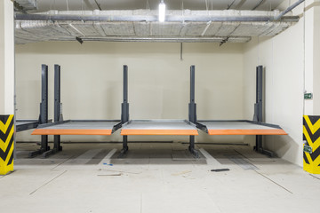 Hydraulic lifts for the car in the underground parking.