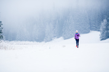 Winter running woman, jogging inspiration and motivation - 94994520