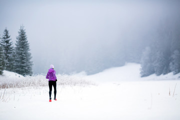 Fototapeta na wymiar Winter running woman, jogging inspiration and motivation