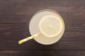 lemonade with fresh slice lemon on wooden background