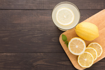 lemonade with fresh slice lemon on wooden background