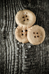 Cheese pastry shape like a button on old light grey wooden table