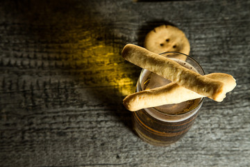 Cheese pastry and glass of light beer on light grey table. Selec