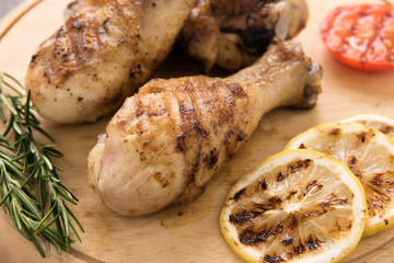 Grilled chicken drumstick on wooden background